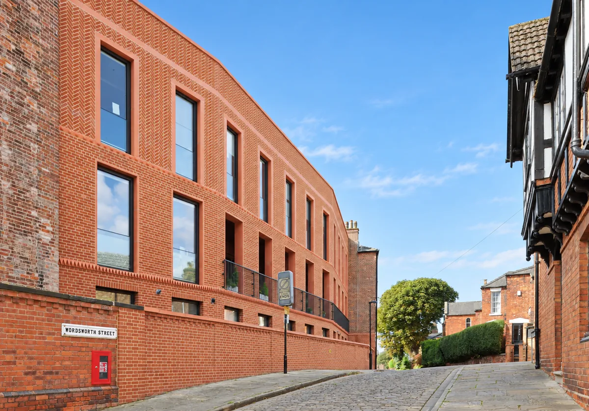 Bailgate Court, Lincoln &mdash; new red-brick terrace curving along a cobbled street